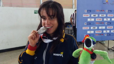 Laura Rivera mordiendo medalla